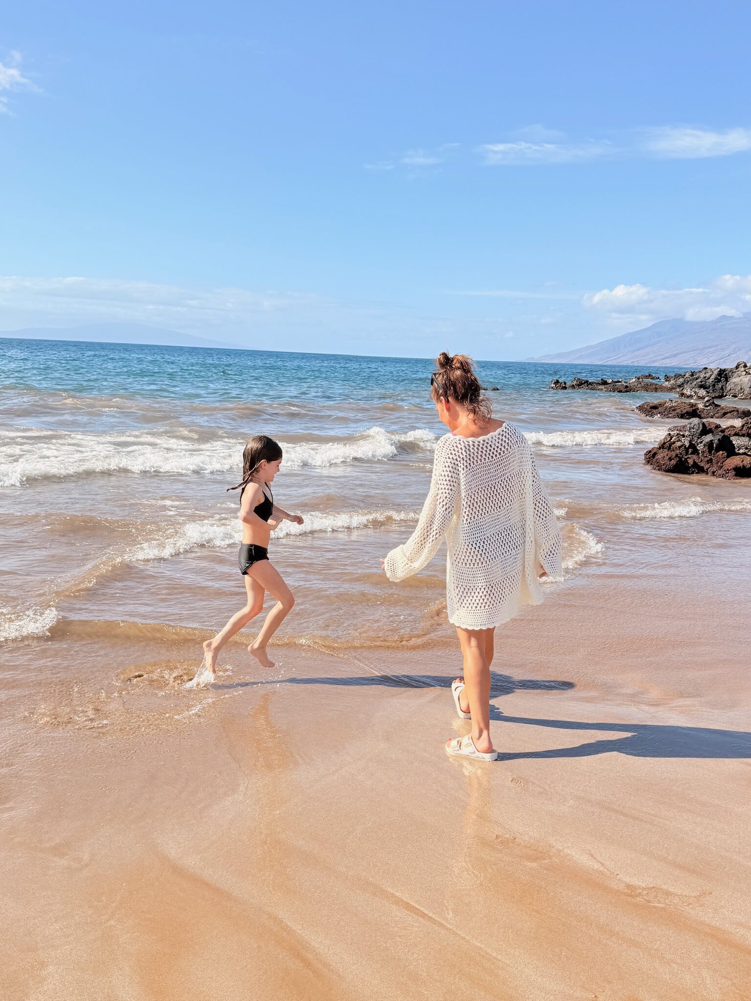 Jillian and daughter Annie walking on the beach