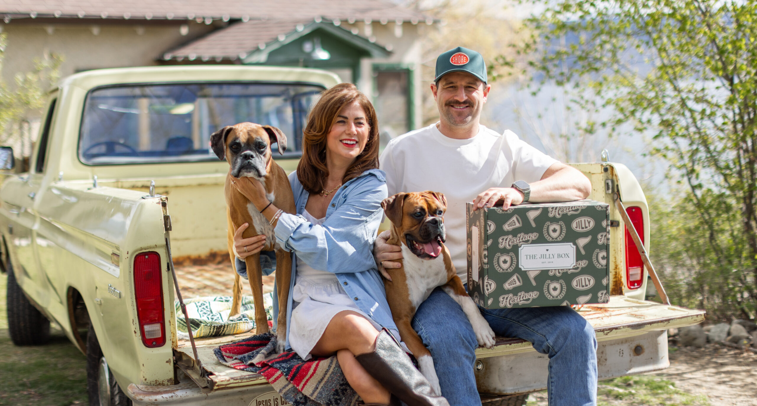 Jillian, Justin, Peaches and Churros sitting on the back of a truck with The 2026 Heritage Box.